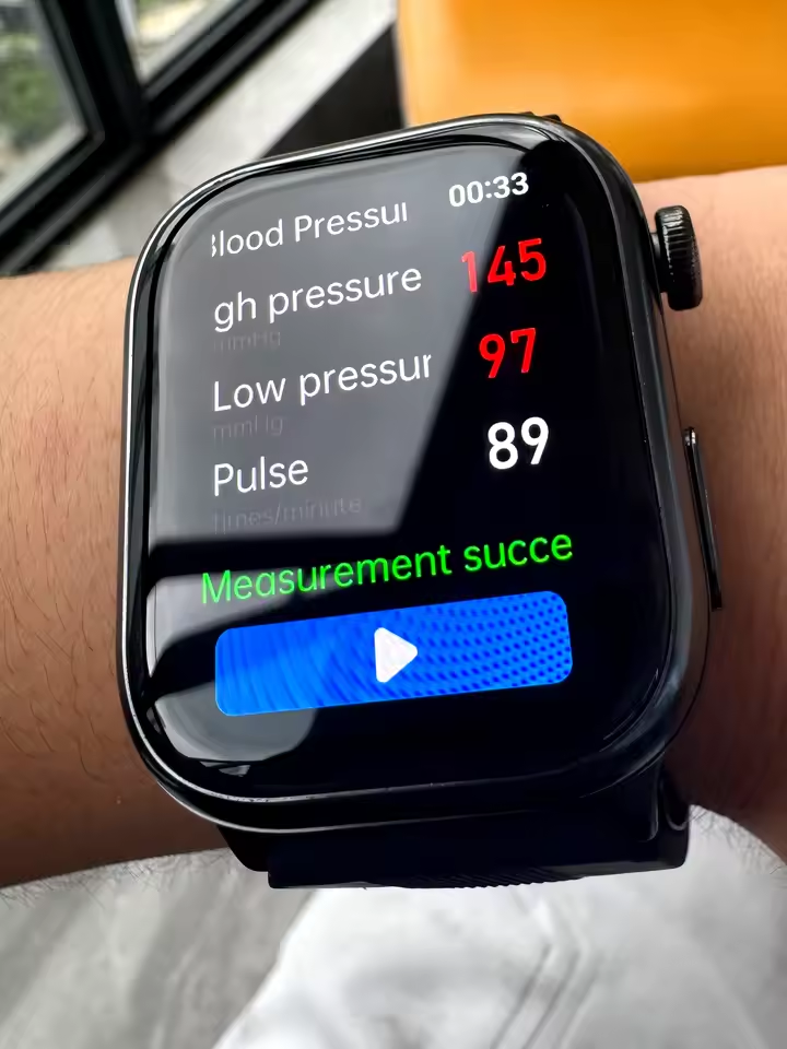 Buyer photo of the smartwatch worn on a wrist showing an on-screen reading