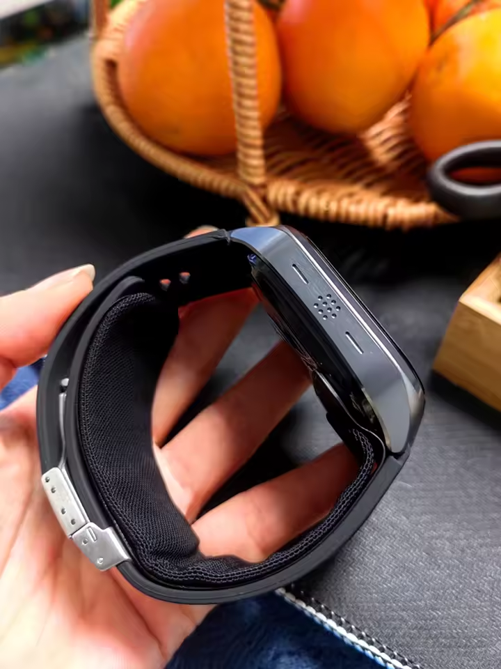 Buyer photo of the smartwatch held in hand showing the strap and clasp