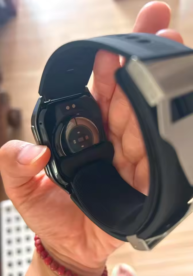 Buyer photo of the underside of the smartwatch held in hand